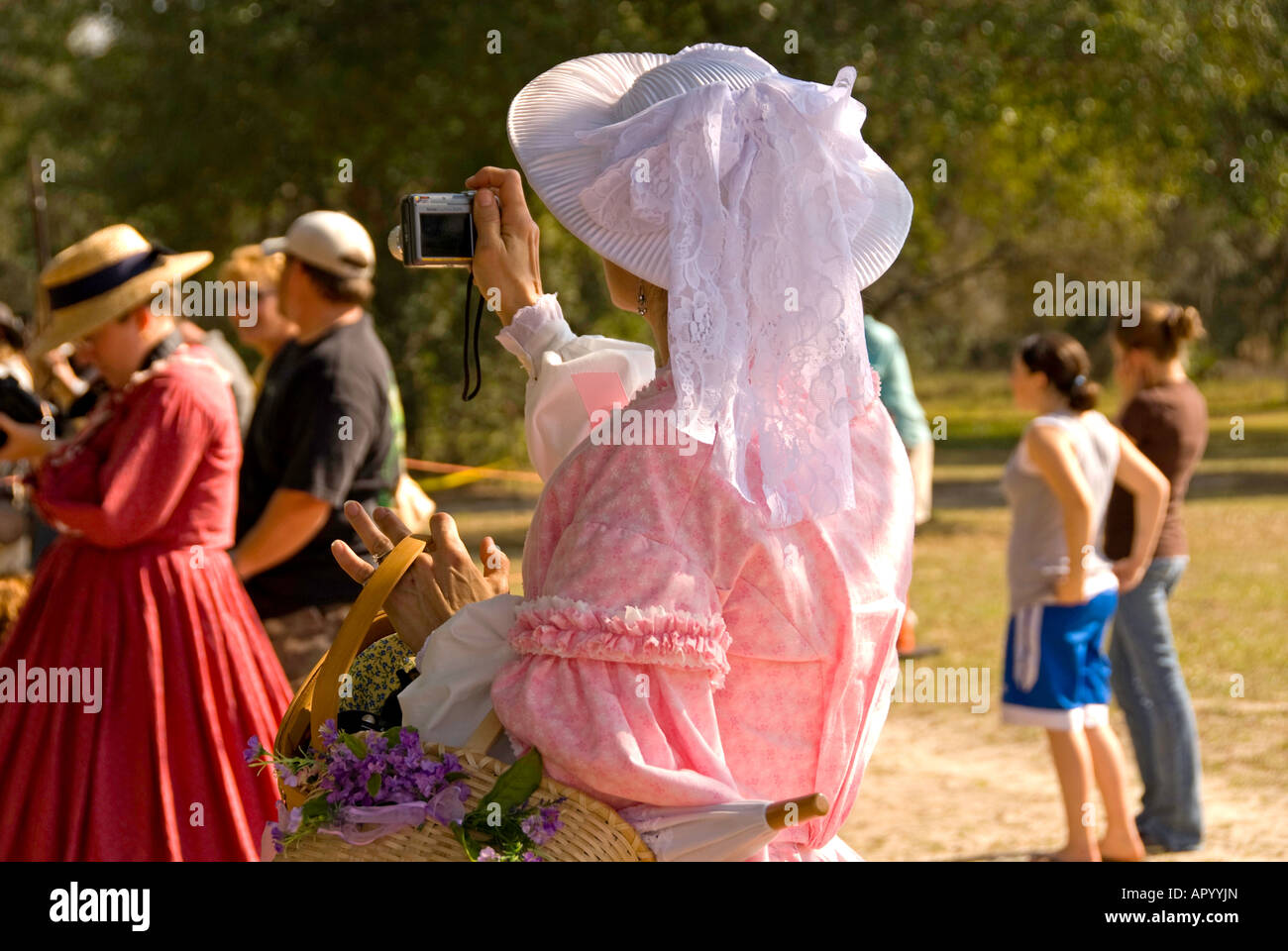 Woman in Civil War era clothing with digital camera horizontal Stock Photo