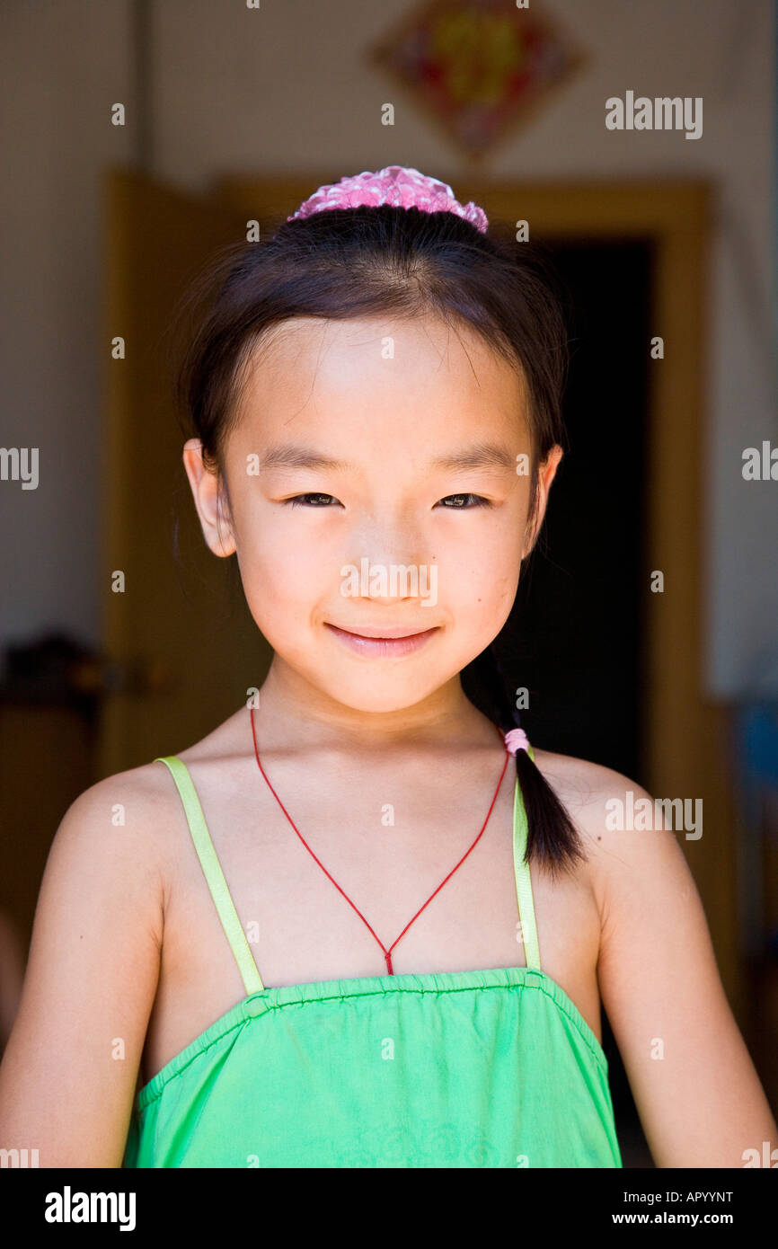 Young asian oriental peasant Chinese girl in green dress full face ...