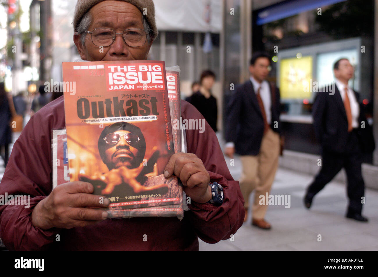 A homeless man selling The Big Issue magazine in Ginza Japan 2004 Stock Photo