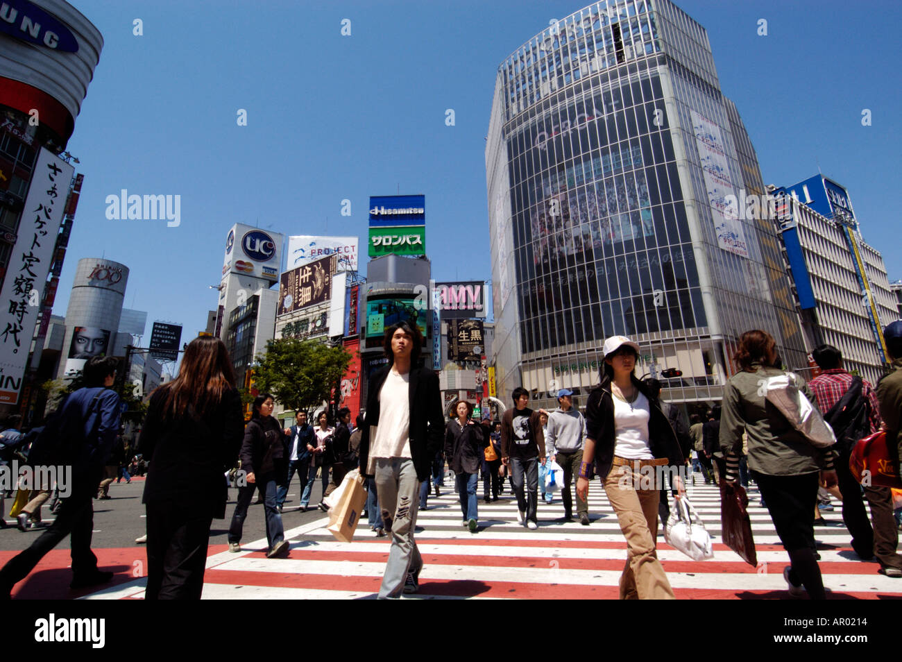 Pedestrians cross busy Hachiko crossing in Shibuya Tokyo Japan Stock Photo