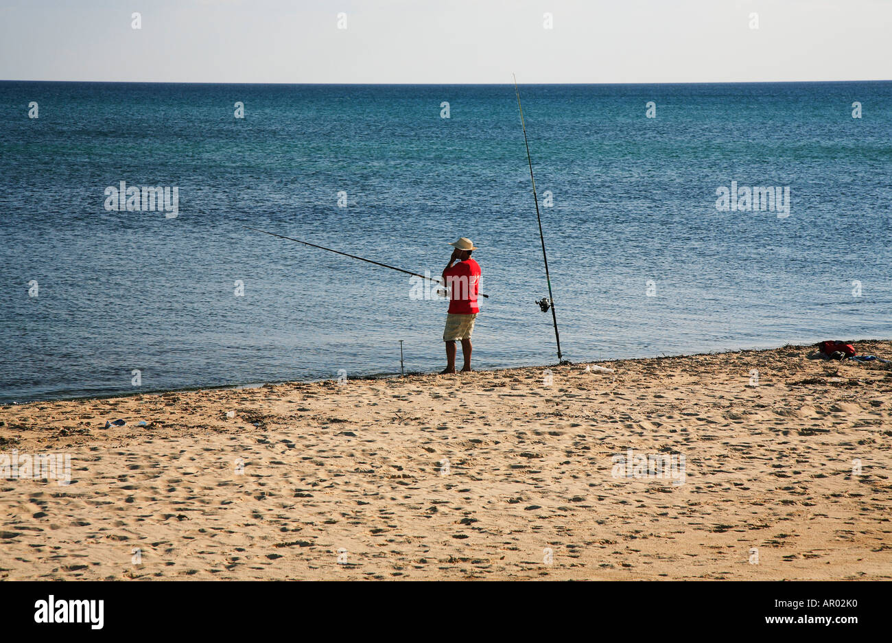 Angler on the beach of Hammamet, Tunisia Stock Photo