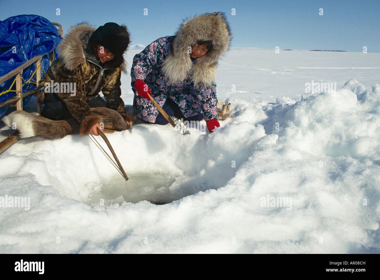 Natives Ice fishing in Kotzebue Western Alaska winter Stock Photo Alamy