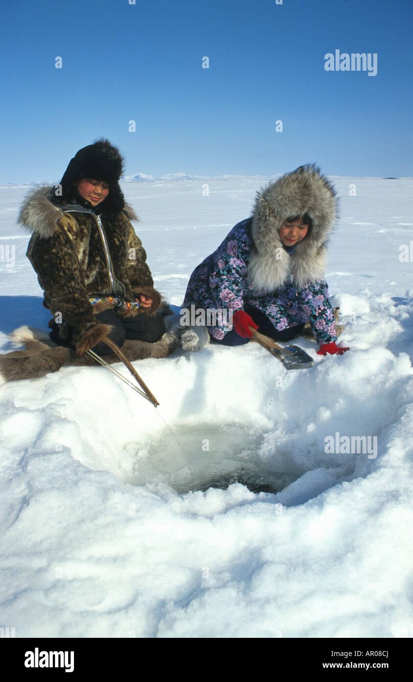 Natives Ice fishing in Kotzebue Western Alaska winter Stock Photo