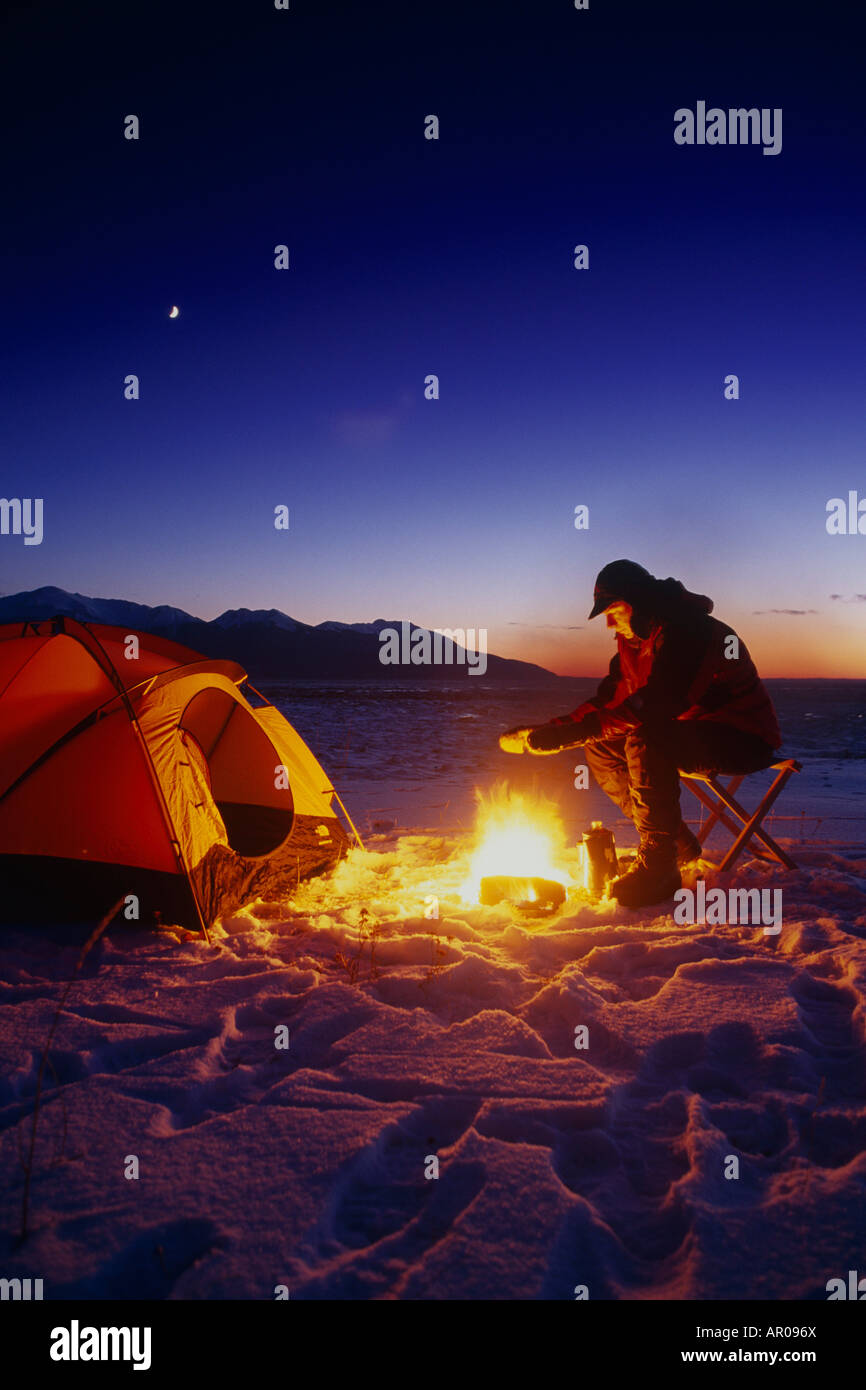 Man by Campfire & Tent Winter Chugach SP SC AK Stock Photo
