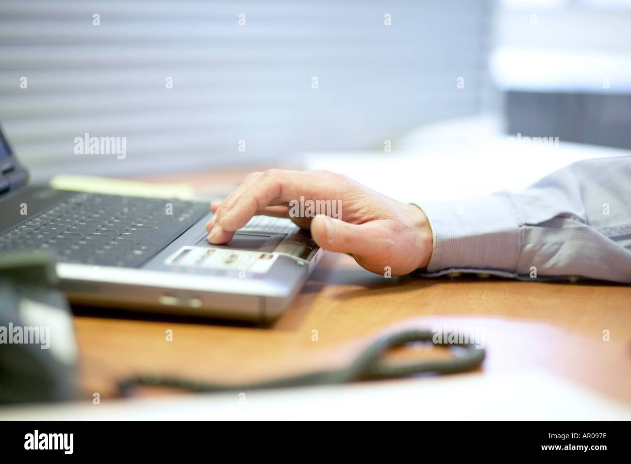 close up of mans hands typing on  laptop computer keyboard Stock Photo