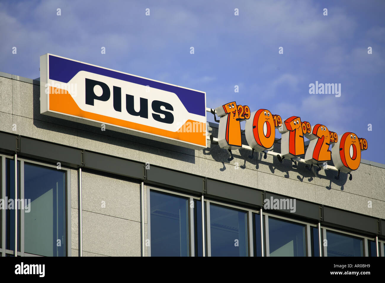 Plus discount shop sign on a office building Stock Photo