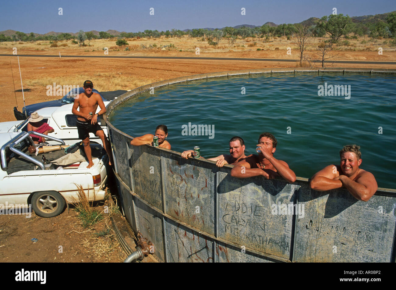 fun cooling off in bore water tank, Kimberley, West Australia, Australia Stock Photo