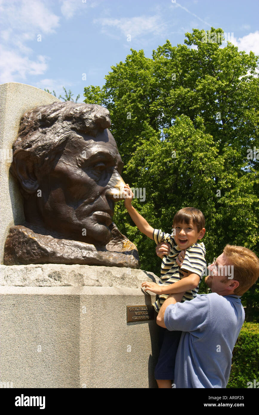 ILLINOIS Springfield Father hold young son so can rub Abraham Lincolns nose Oak Ridge Cemetery site of Lincolns tomb Stock Photo