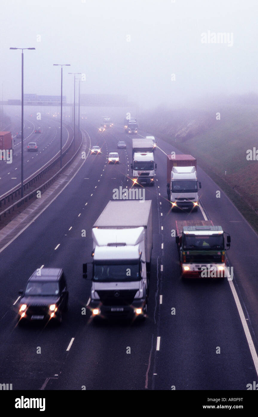 traffic travelling on the A1 M1 motorway through thick fog Leeds Yorkshire UK Stock Photo