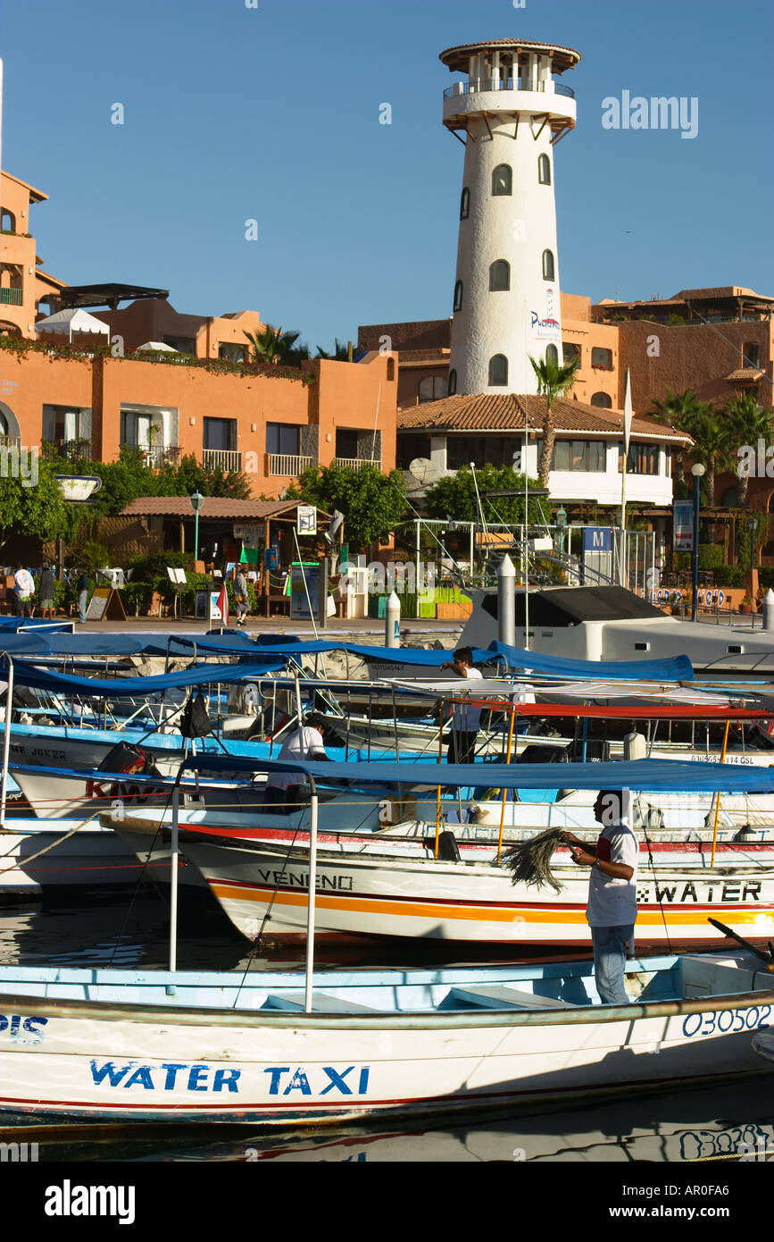 MEXICO Cabo San Lucas Water taxis and boats in marina man clean boat ...