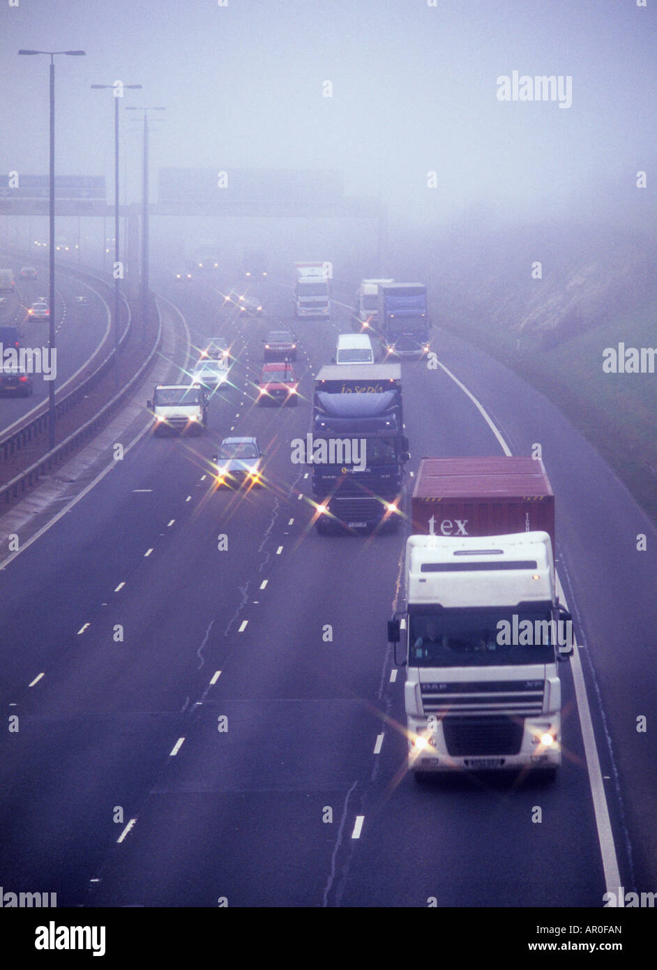 traffic travelling on the A1 M1 motorway through thick fog Leeds Yorkshire UK Stock Photo