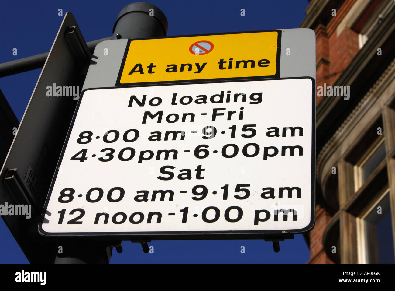 no stopping and loading restriction warning signs for vehicles at roadside in Leeds city centre Yorkshire UK Stock Photo