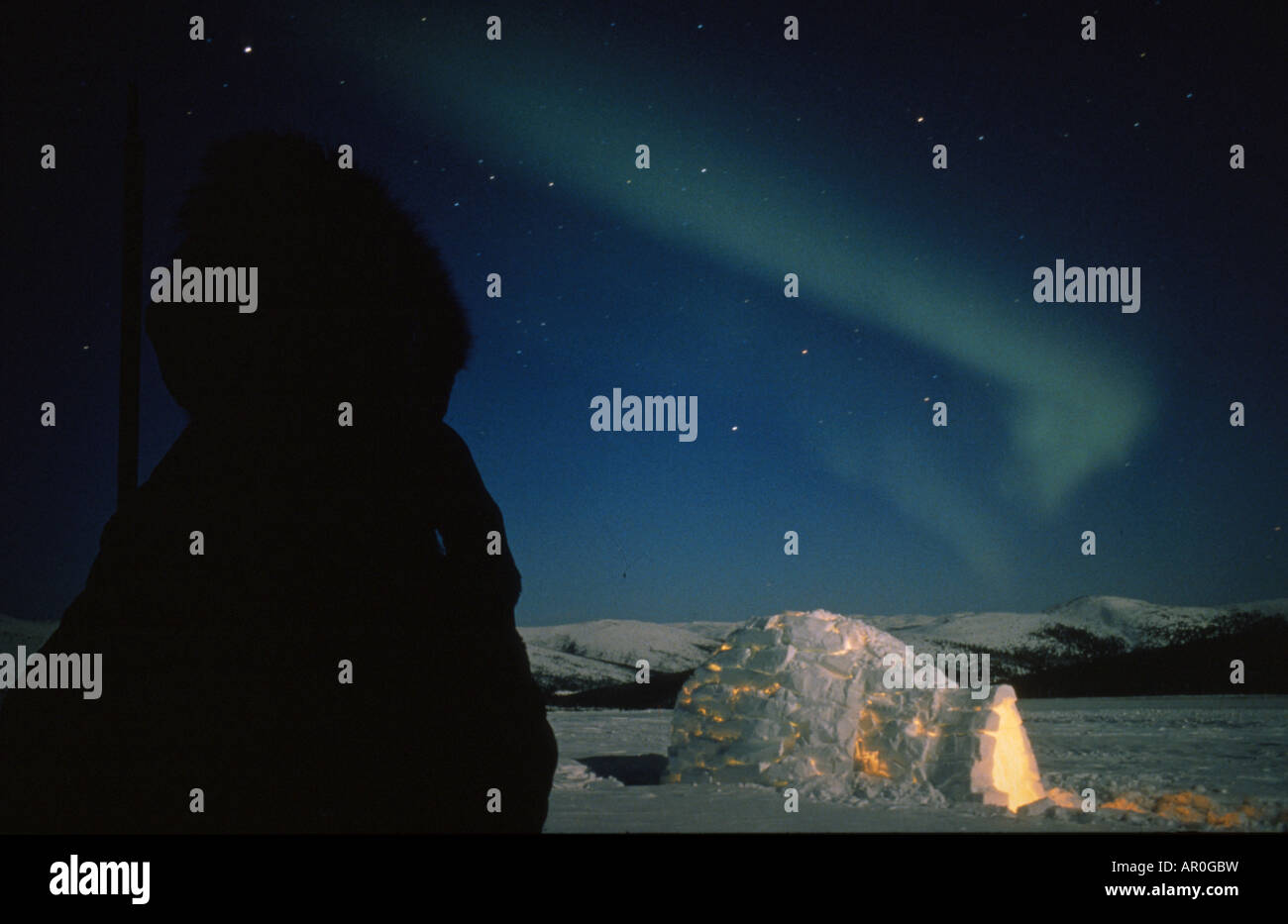 Eskimo man viewing Northern Lights over igloo Alaska composite winter scenic Stock Photo Alamy