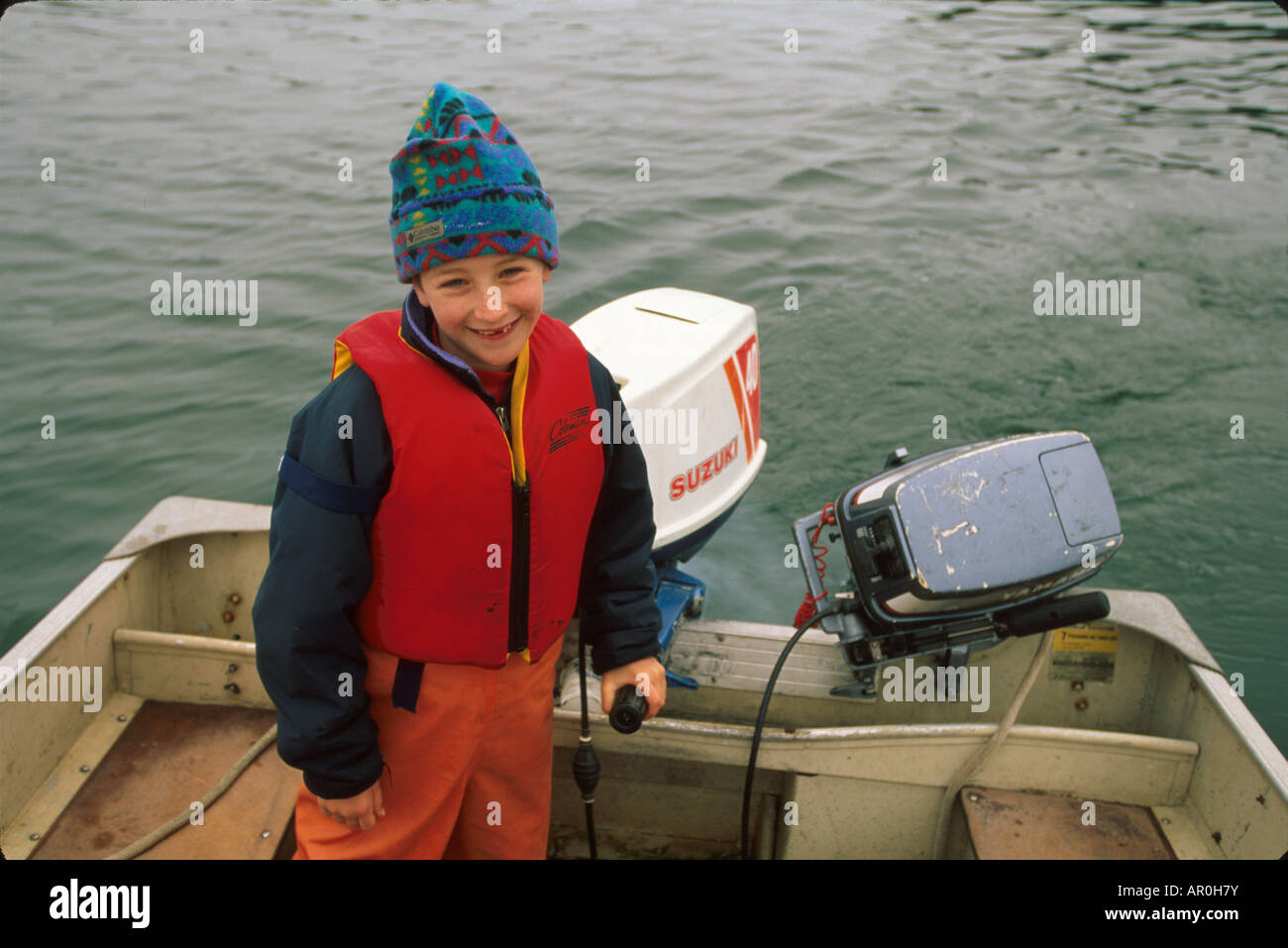 8yearold Boy Driving Skiff Juneau Southeast AK summer portrait Stock
