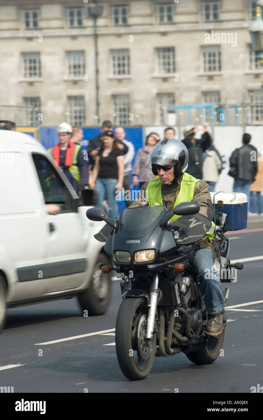 Motorcycle courier traveling in London traffic, England Stock Photo Alamy