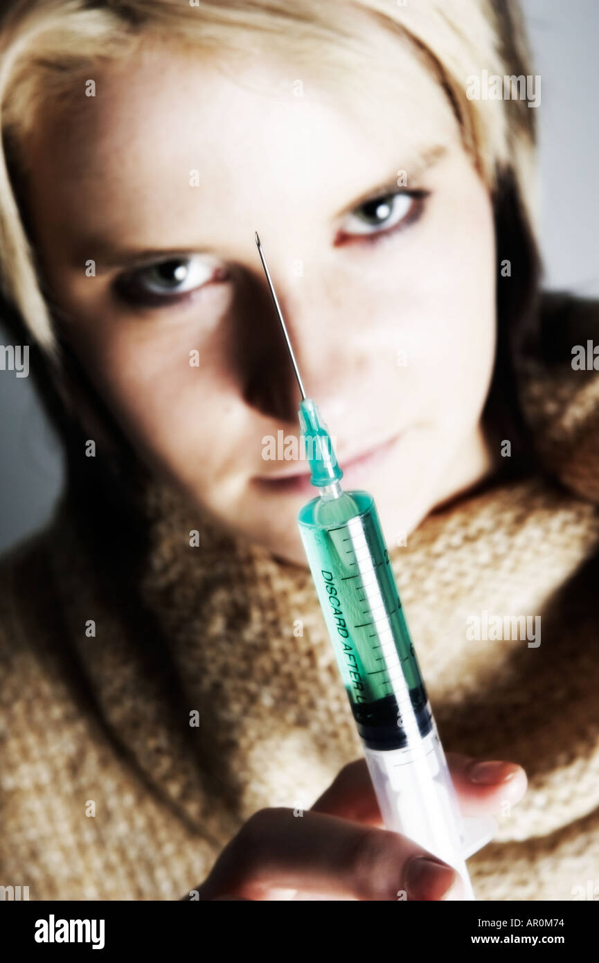 Evil woman holding syringe Stock Photo - Alamy