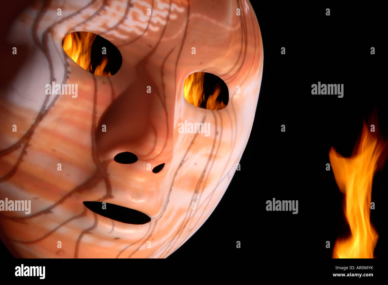 A sinister mask (Playing with fire) Stock Photo