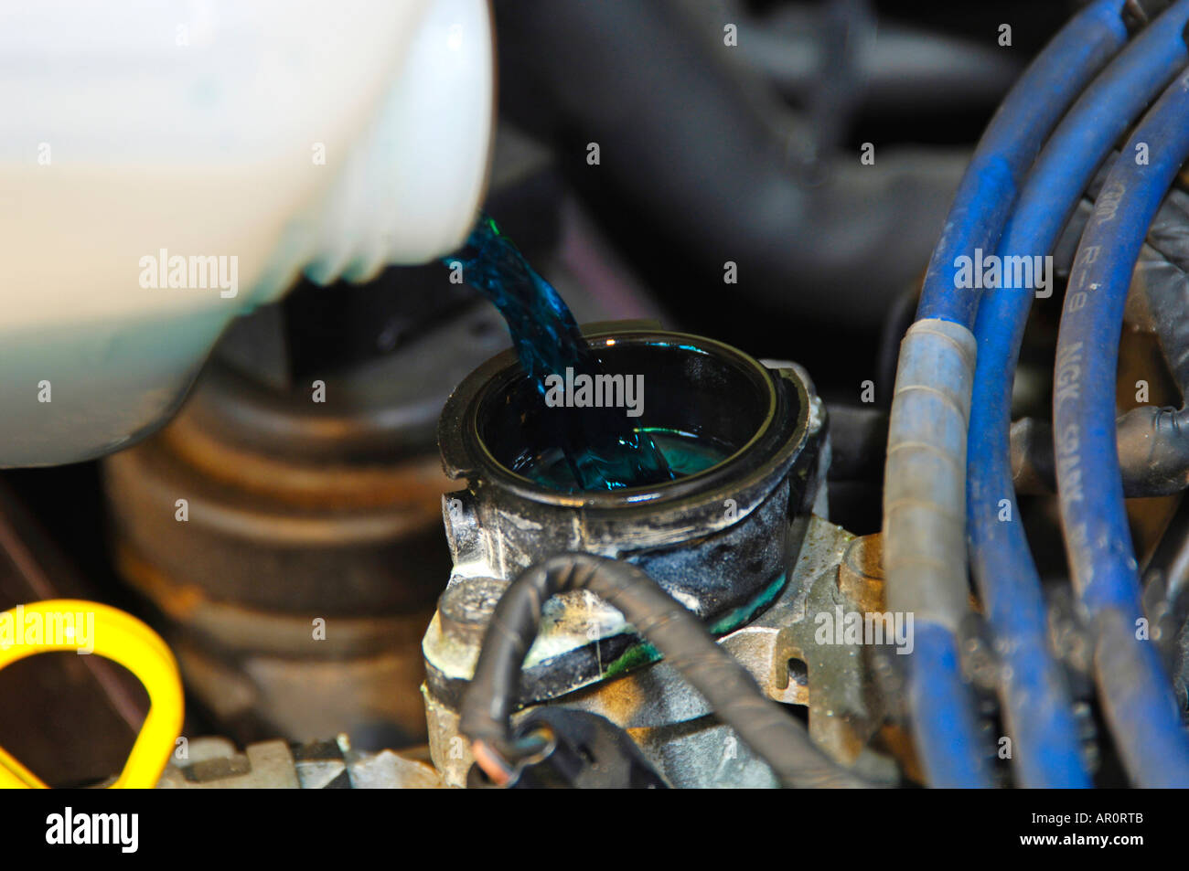 Refilling coolant in an engine Stock Photo