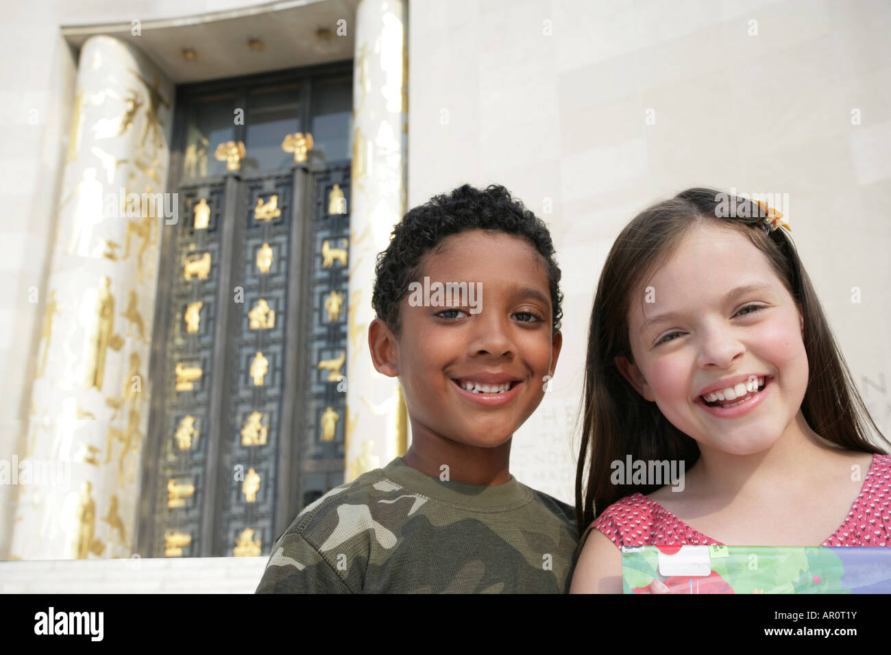 two kids, boy and girl looking at camera Stock Photo - Alamy