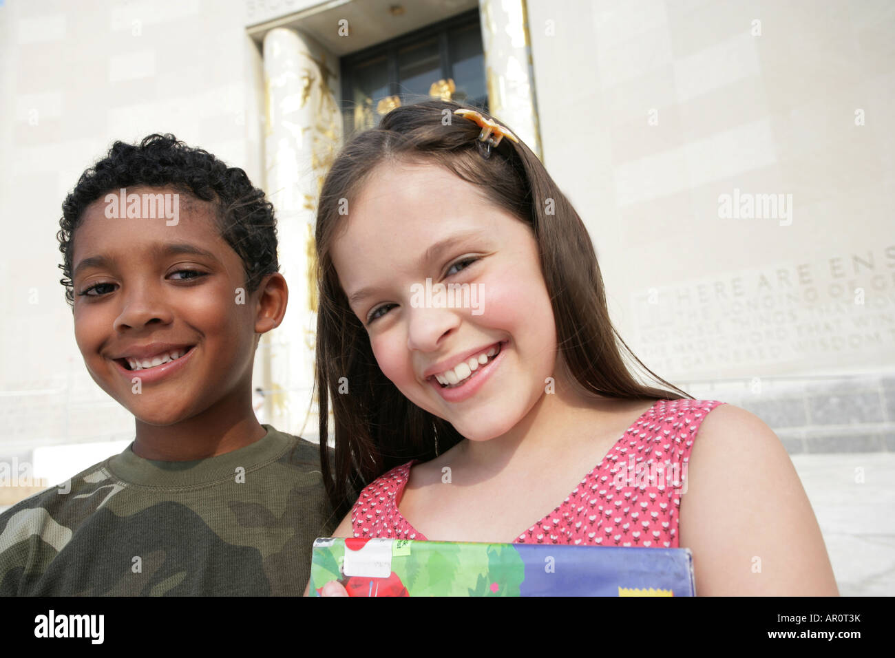 two kids, boy and girl looking at camera Stock Photo - Alamy