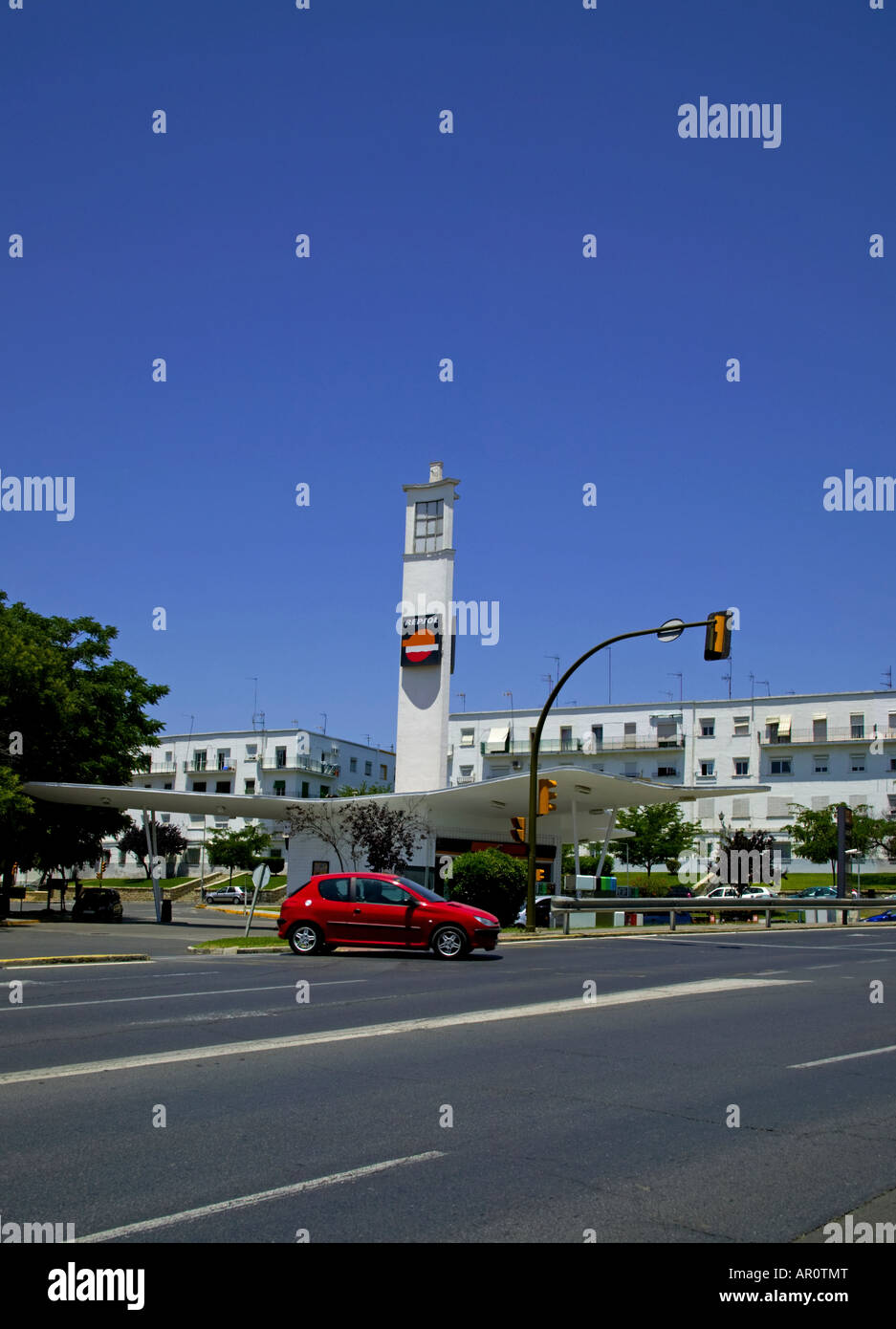 Red car exits fuel station, Huelva, Spain Stock Photo