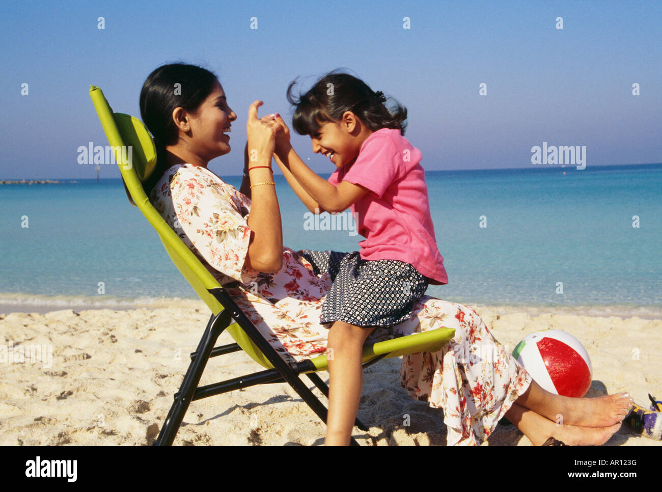 A mother and daughter cherishing happy moments on the beach. Stock Photo
