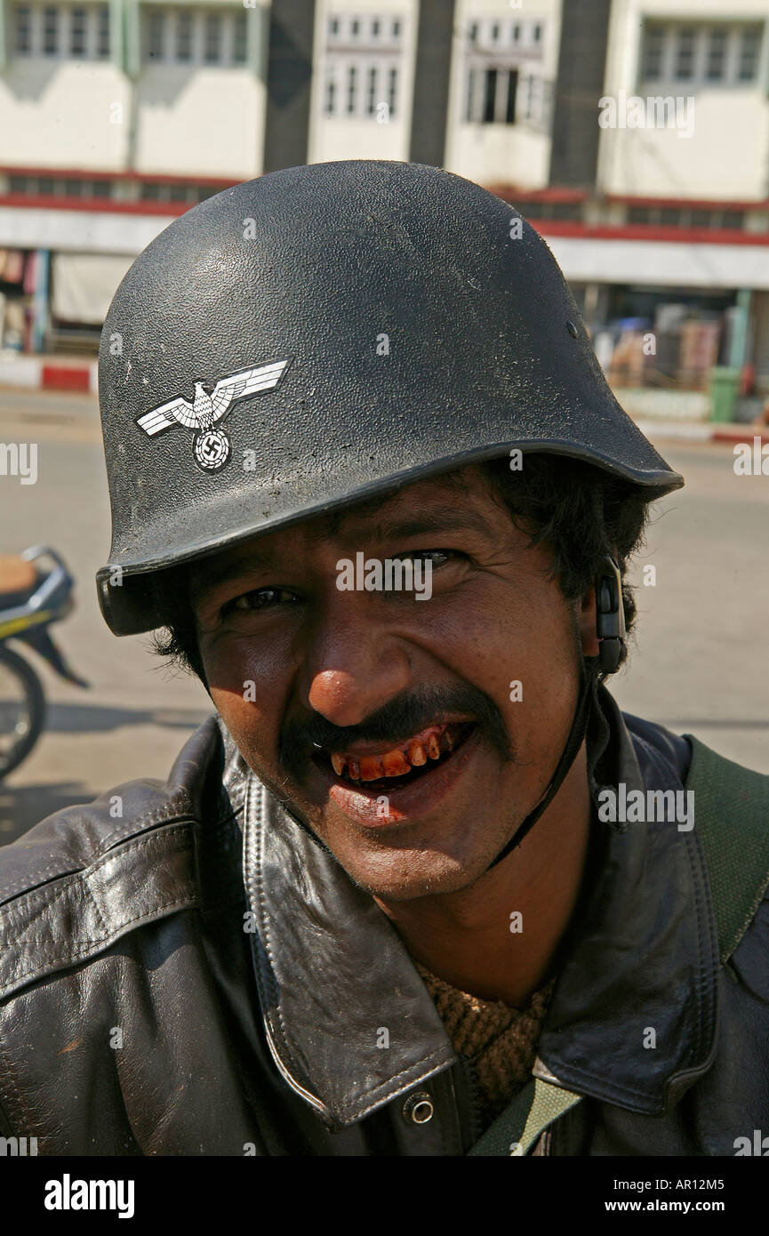 German helmet and symbols, Taunggyi, Burmese man with German military wehrmacht helmet with Swastika and eagle, mistaken as Budd Stock Photo