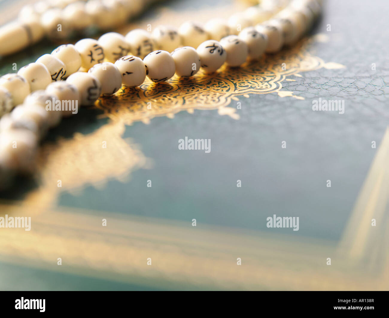 Quran and prayer beads with Arabic letters Stock Photo Alamy