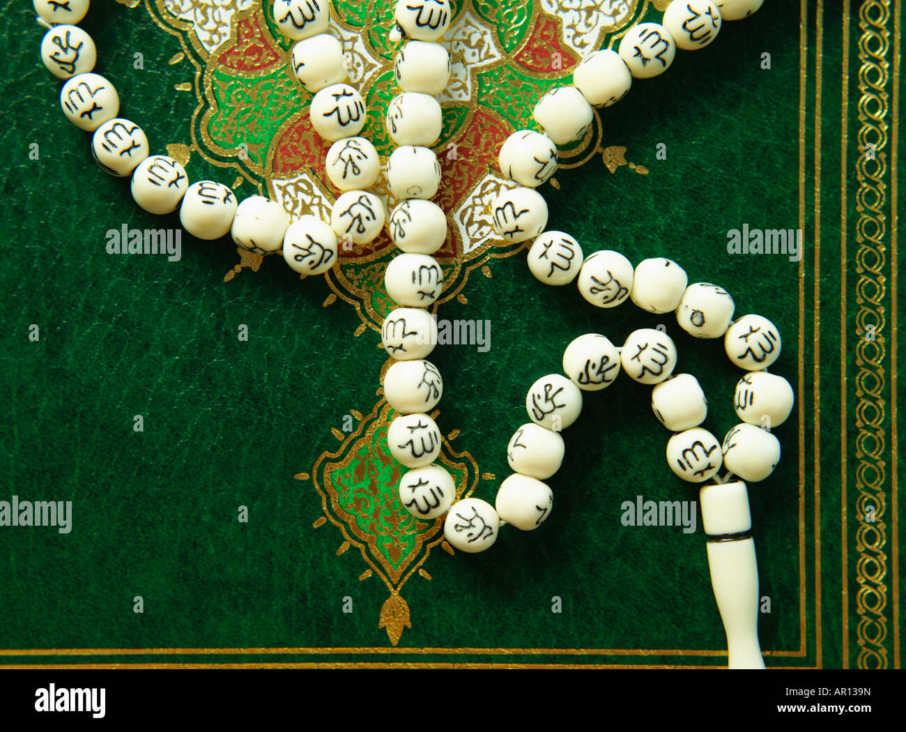 Quran and prayer beads with Arabic letters Stock Photo Alamy