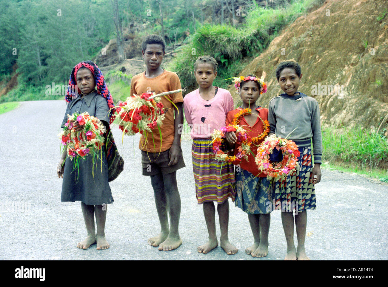 Children with flower garlands Daulo Pass Highlands highway Papua New Guinea Stock Photo