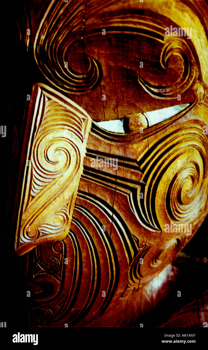 Traditional Maori carving showing face of a warrior, Rotorua, New Zealand Stock Photo