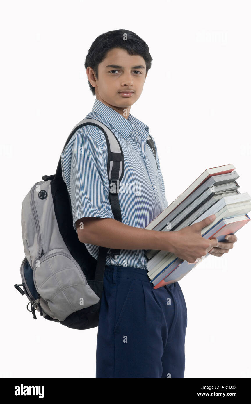 Teenage boy carrying books Stock Photo - Alamy