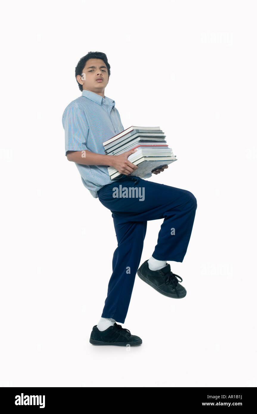 Teenage boy carrying books Stock Photo - Alamy