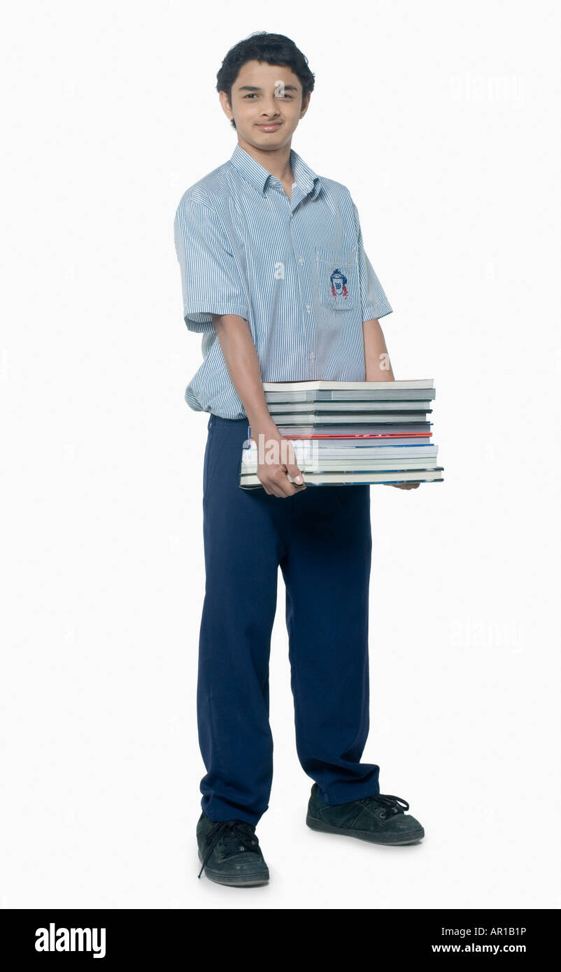 Teenage boy carrying books Stock Photo - Alamy