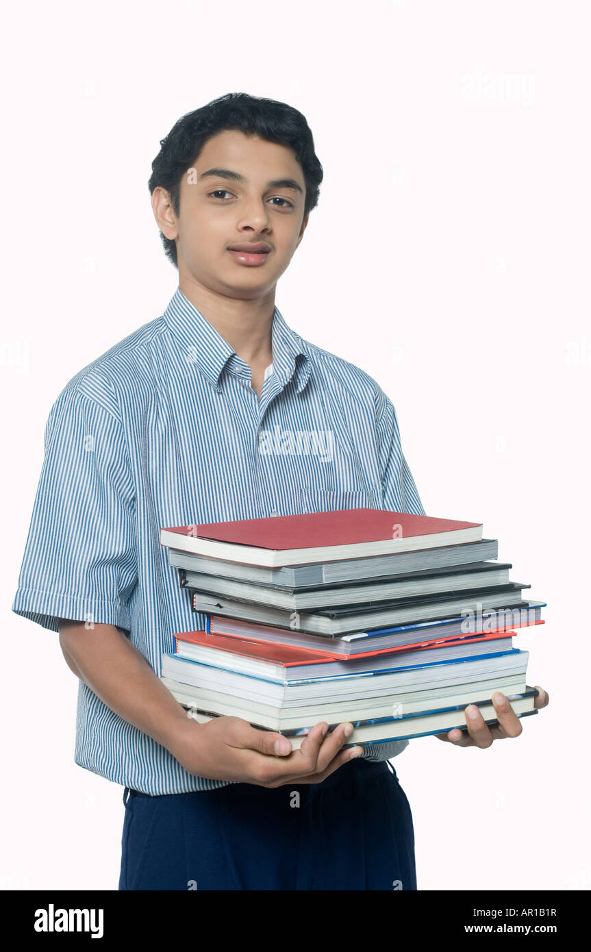 Teenage boy carrying books Stock Photo - Alamy