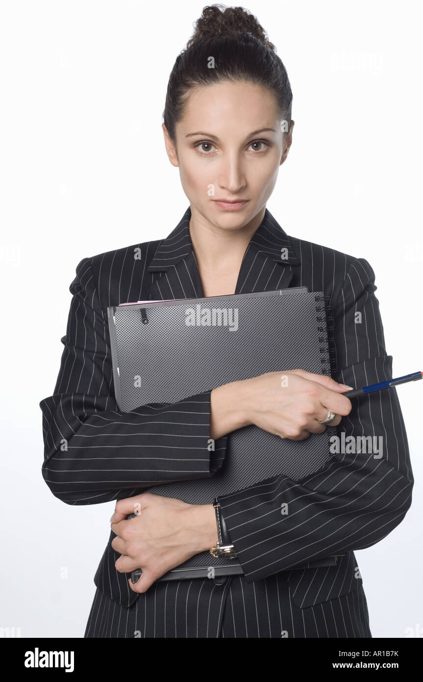 Young woman holding file, thinking Stock Photo - Alamy