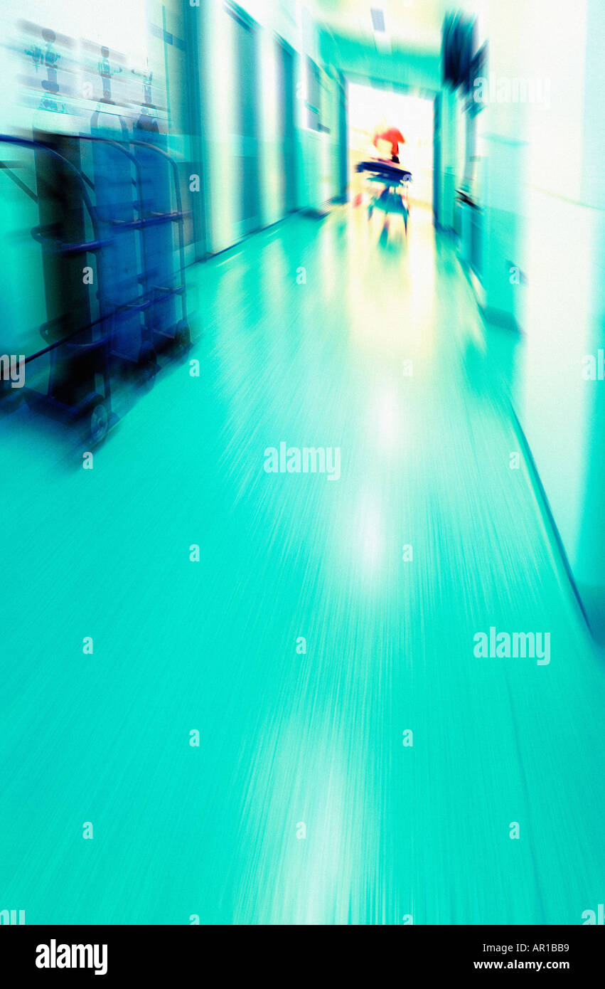 Motion-blurred emergency shot of a patient being rushed through a hospital corridor Stock Photo