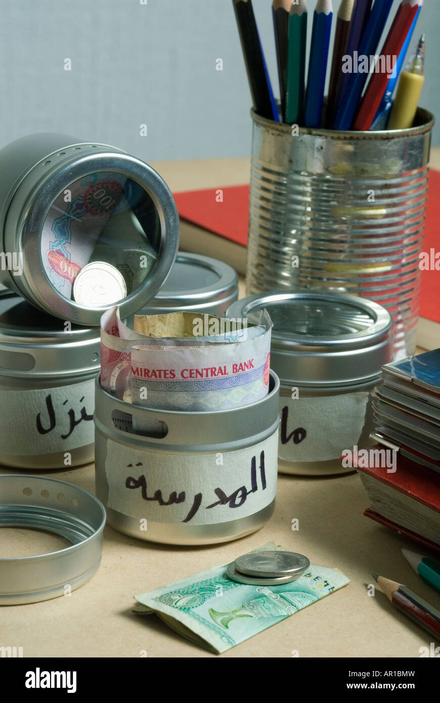 Money in containers, close-up Stock Photo - Alamy
