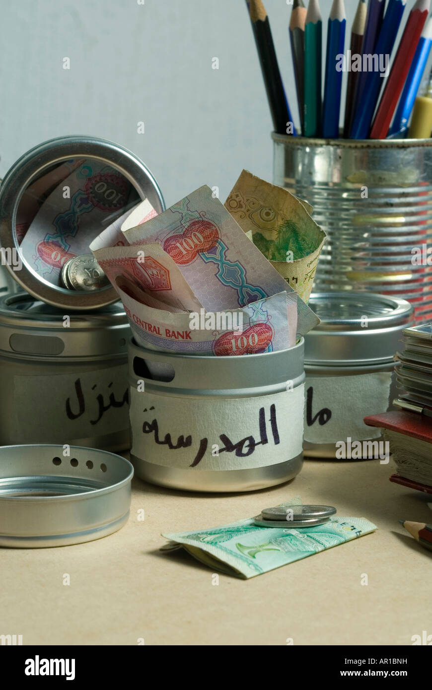 Money in containers, close-up Stock Photo - Alamy