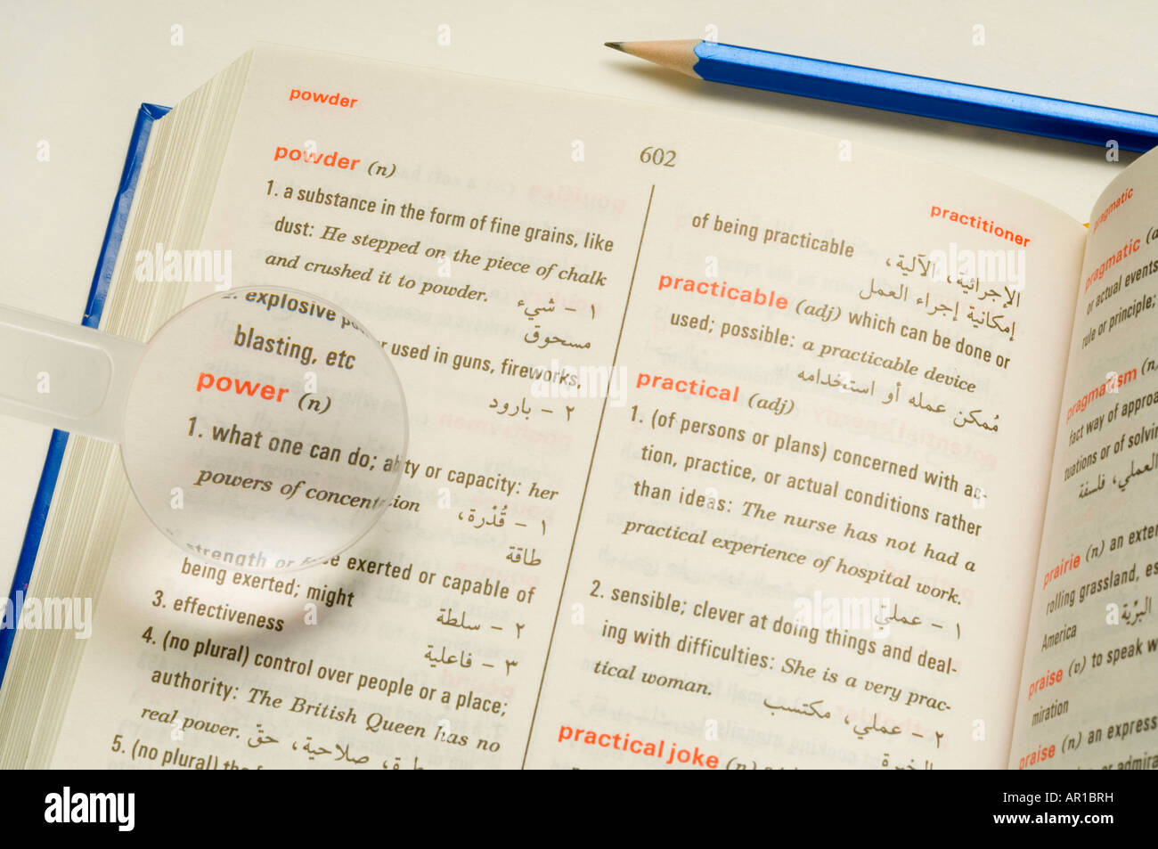 Magnifier on dictionary, closeup, elevated view Stock Photo Alamy