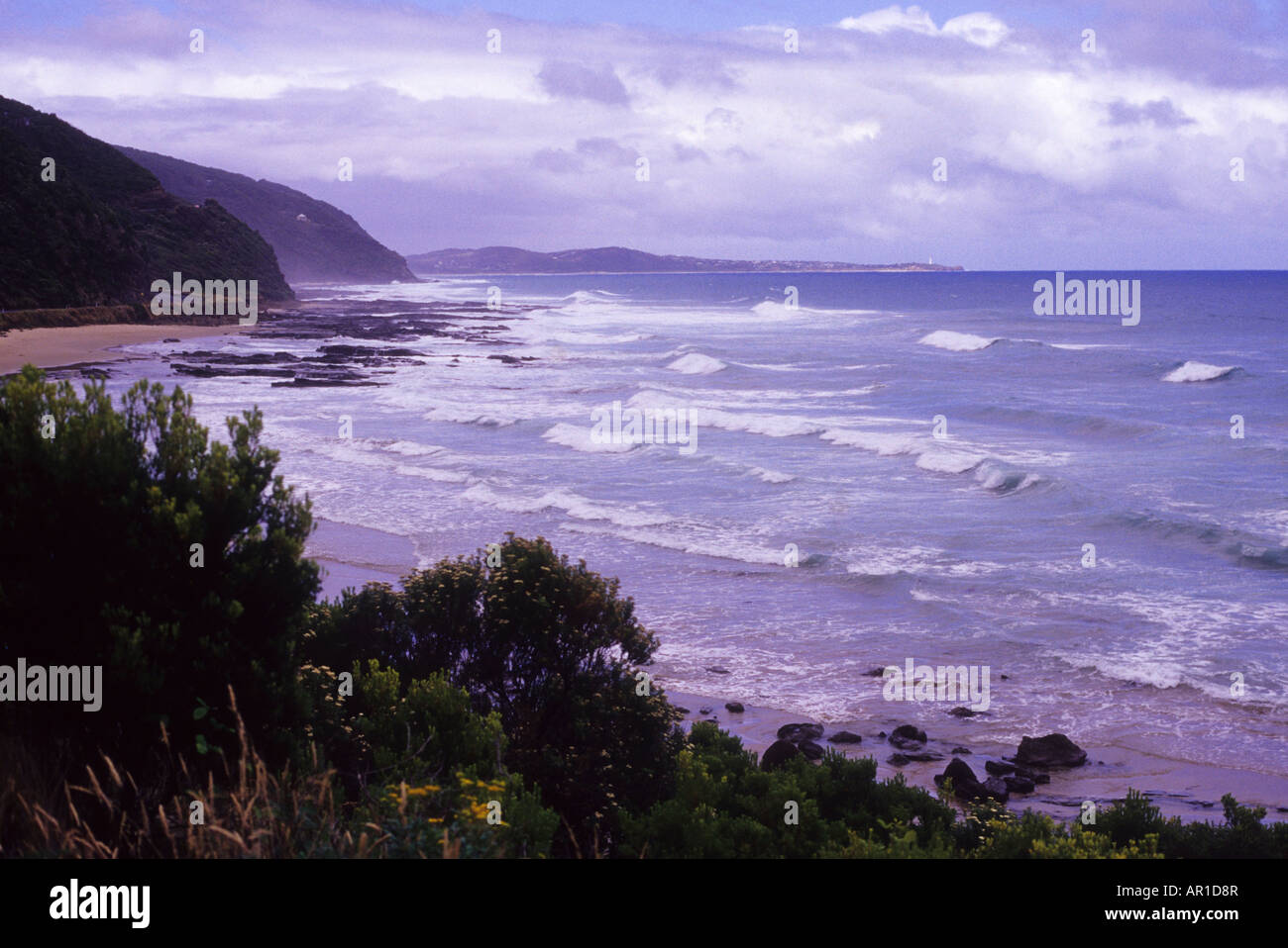 Waves batter the coast of Victoria during an overcast day of rough seas ...