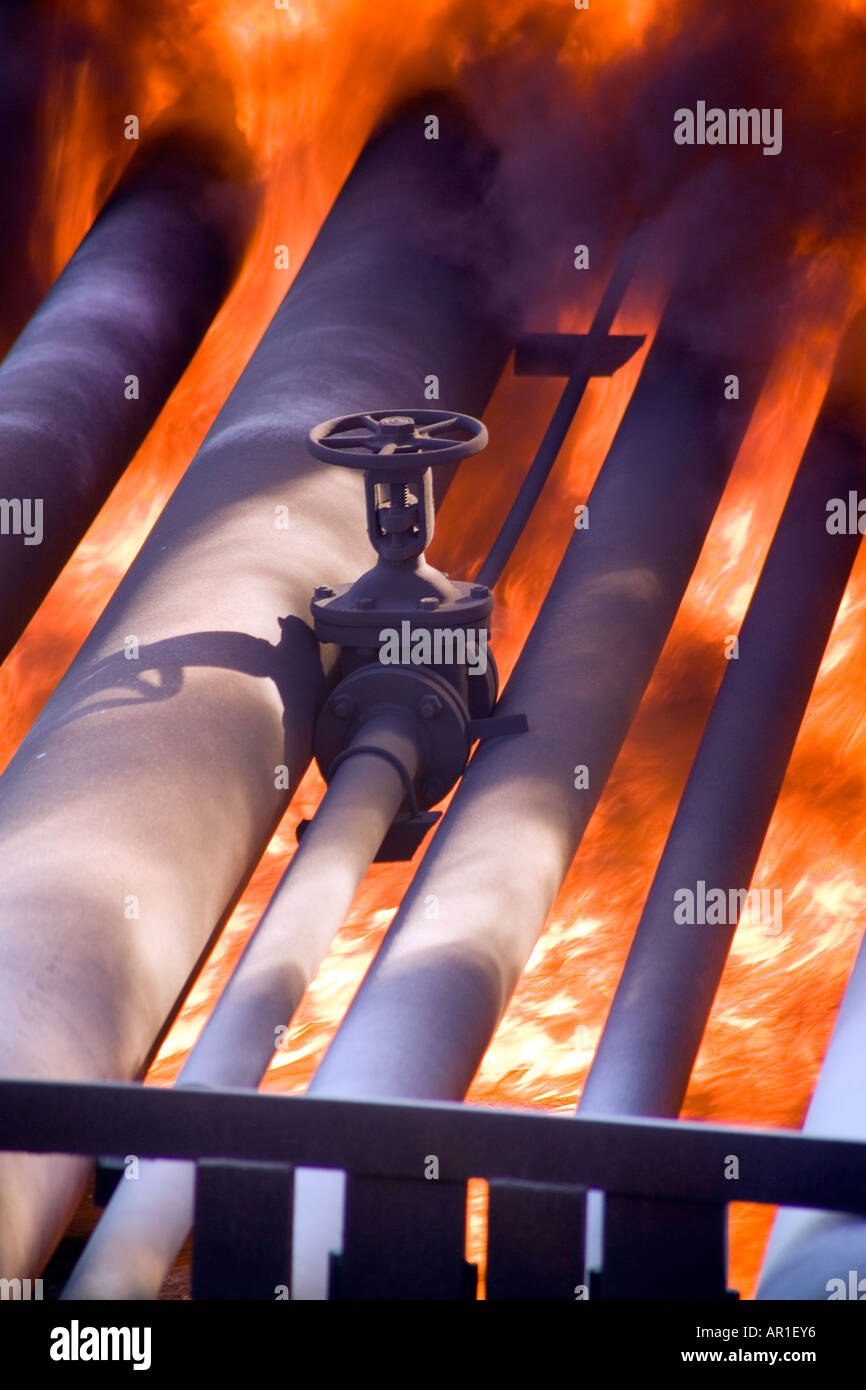 Sweating Pipe Fire Liquid on fire below industrial pipe rack and valve Stock Photo - Alamy
