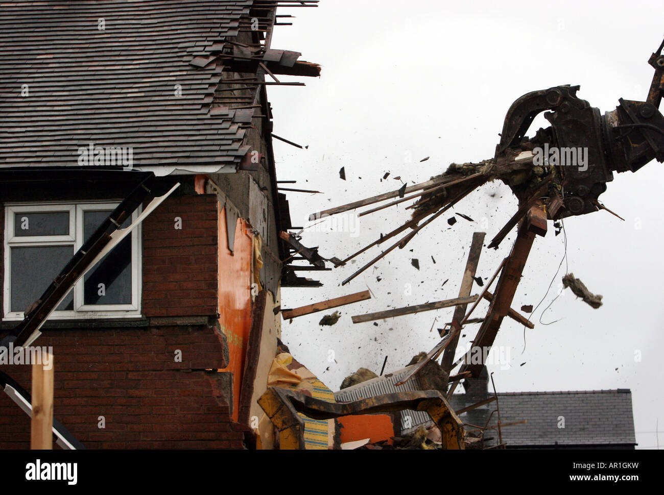 A UK house is demolished as the roof is ripped off in the UK.The UK Government stand accused of inflating house prices Stock Photo
