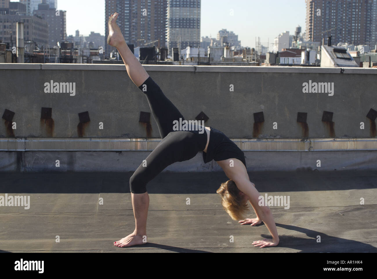 Model released New York CIty Thirty years old blond woman practising yoga in a sunny morning in mid town Manhattan exercise heal Stock Photo
