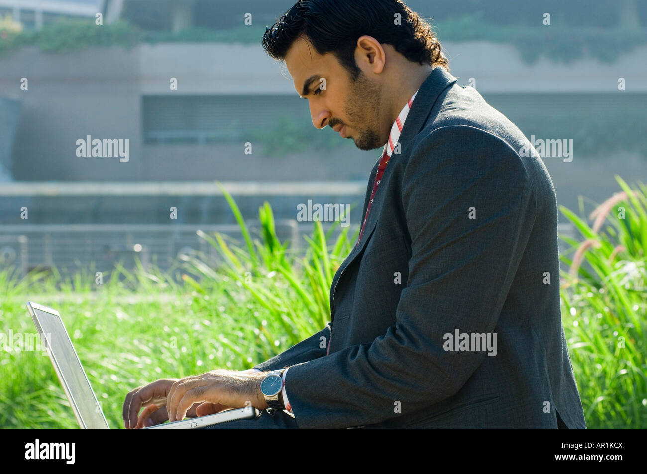 Young man with a laptop computer outdoors Stock Photo - Alamy