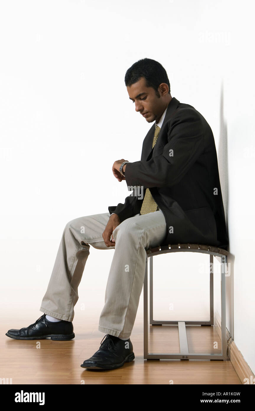 Young man sitting waiting Stock Photo Alamy Young man sitting waiting Stock Photo Alamy