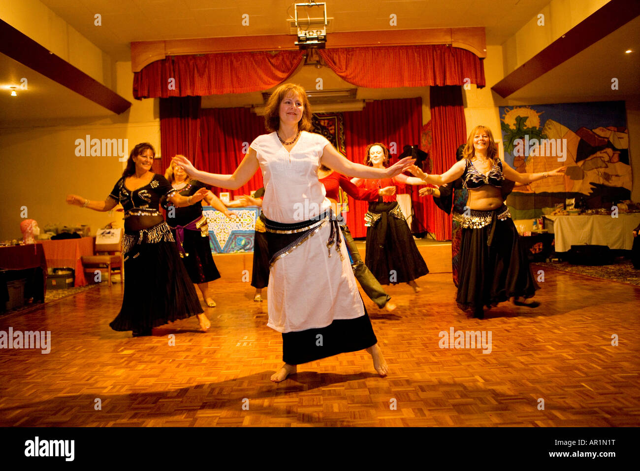 group of women enjoying a belly dance class in a village hall ladies