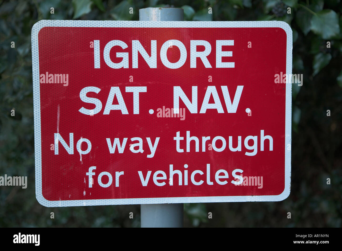 Red 'Ignore Sat Nav' sign. No way through for vehicles. Stock Photo