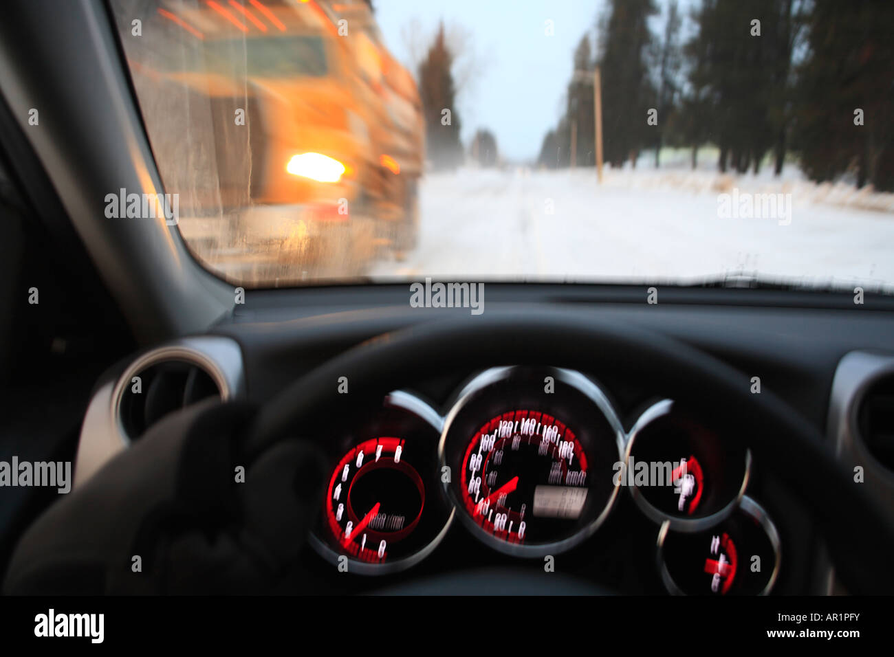 Driver passing snowplow in winter Smithers British Columbia Canada