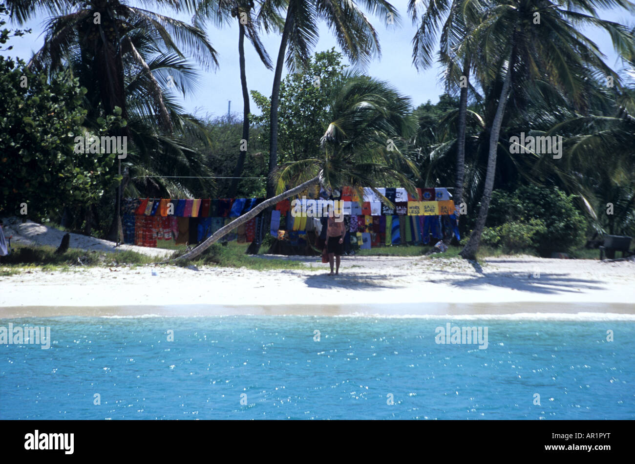 Grenadines shopping (01). Towels, T-shirts and wraps beach style under the palm trees on a tropical Caribbean island. Stock Photo